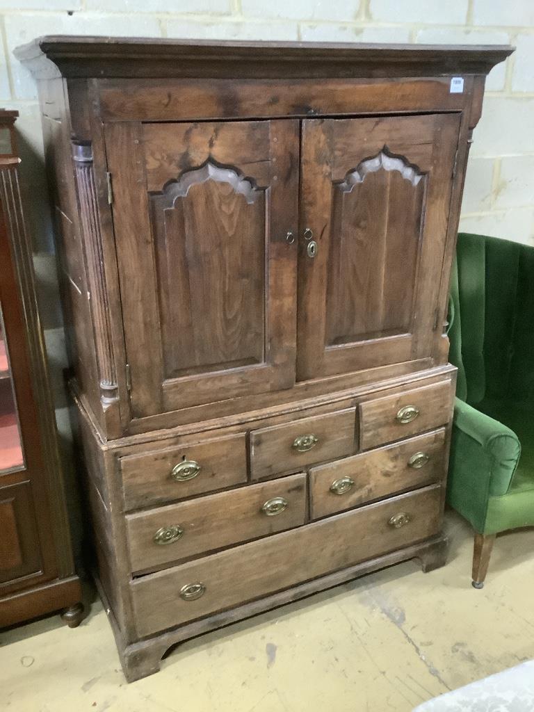 A mid 18th century oak two part bow fronted Dower chest / linen press, with doors enclosing shelves and six drawers, width 121cm